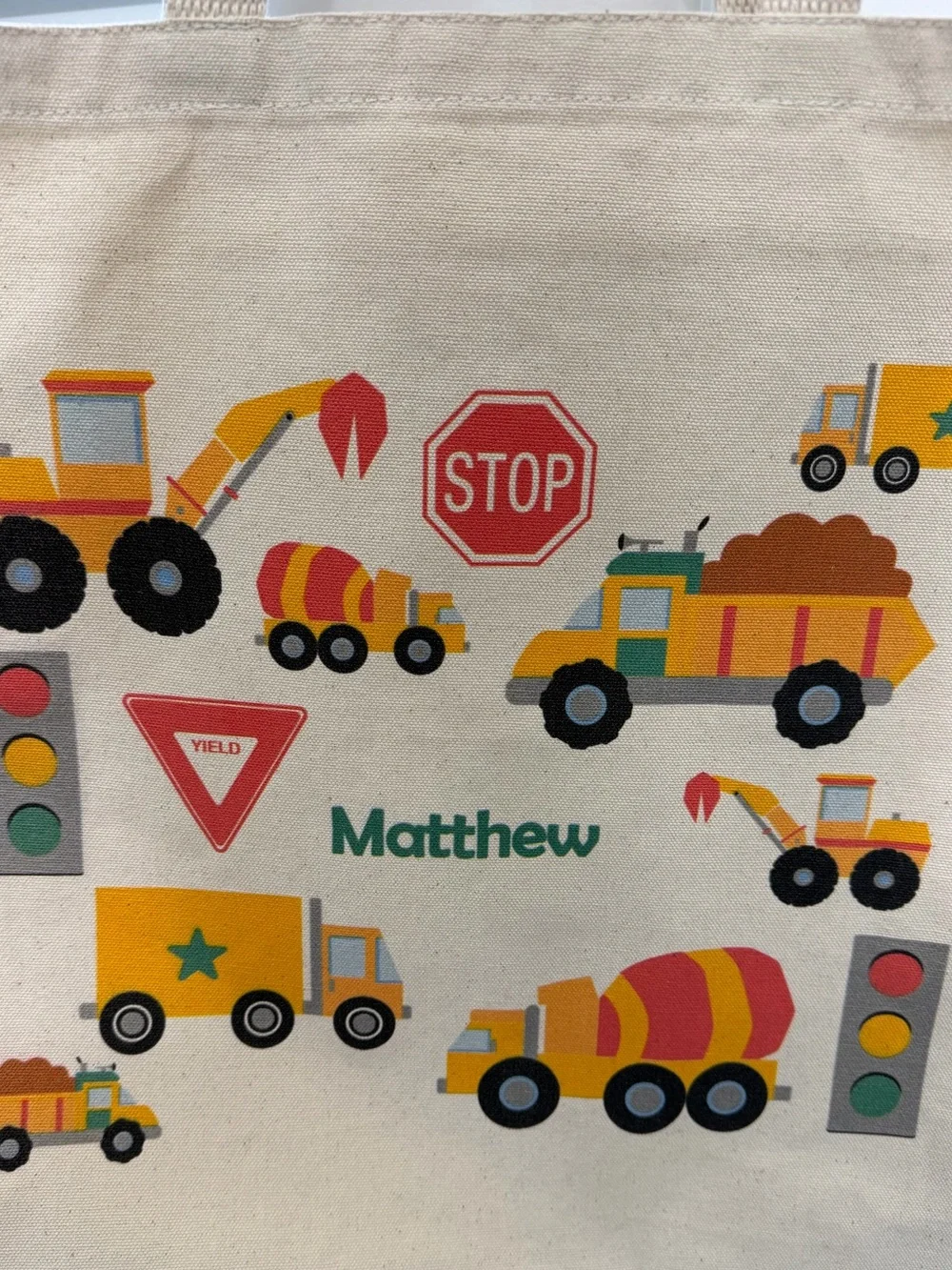 Personalized “Matthew” Kids Canvas Toy Bag - Cream with Yellow & Orange Trucks
